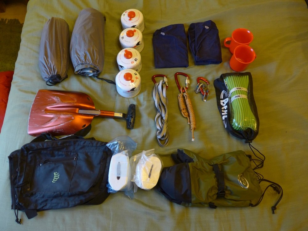 Some mountaineering items laid out on the bed